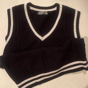 Black sweater vest with white trim